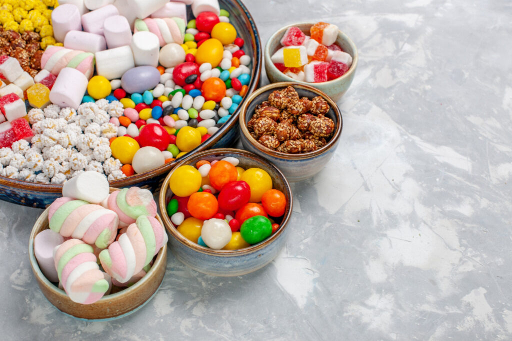 front close view candy composition different colored candies with marshmallow white desk