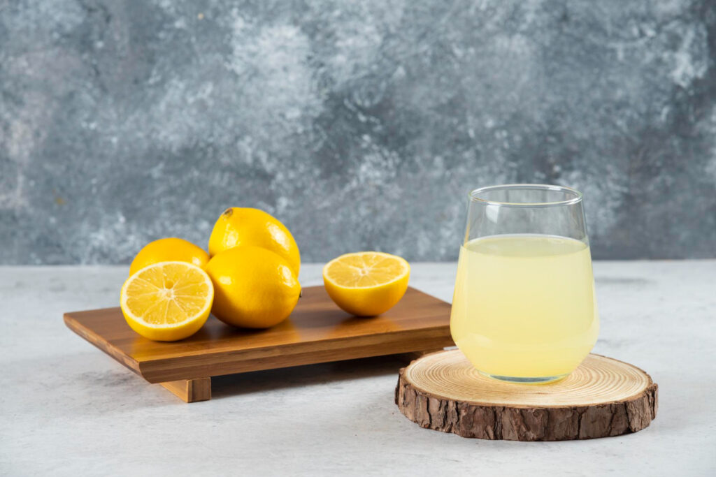 glass cup fresh lemon juice wooden board