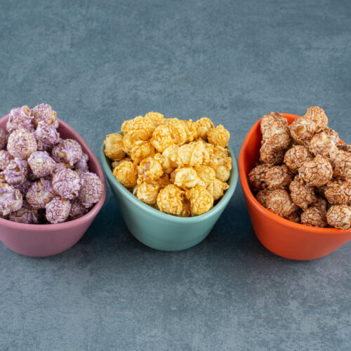 colorfully assorted variety popcorn candy flavors assorted small bowls marble background high quality photo