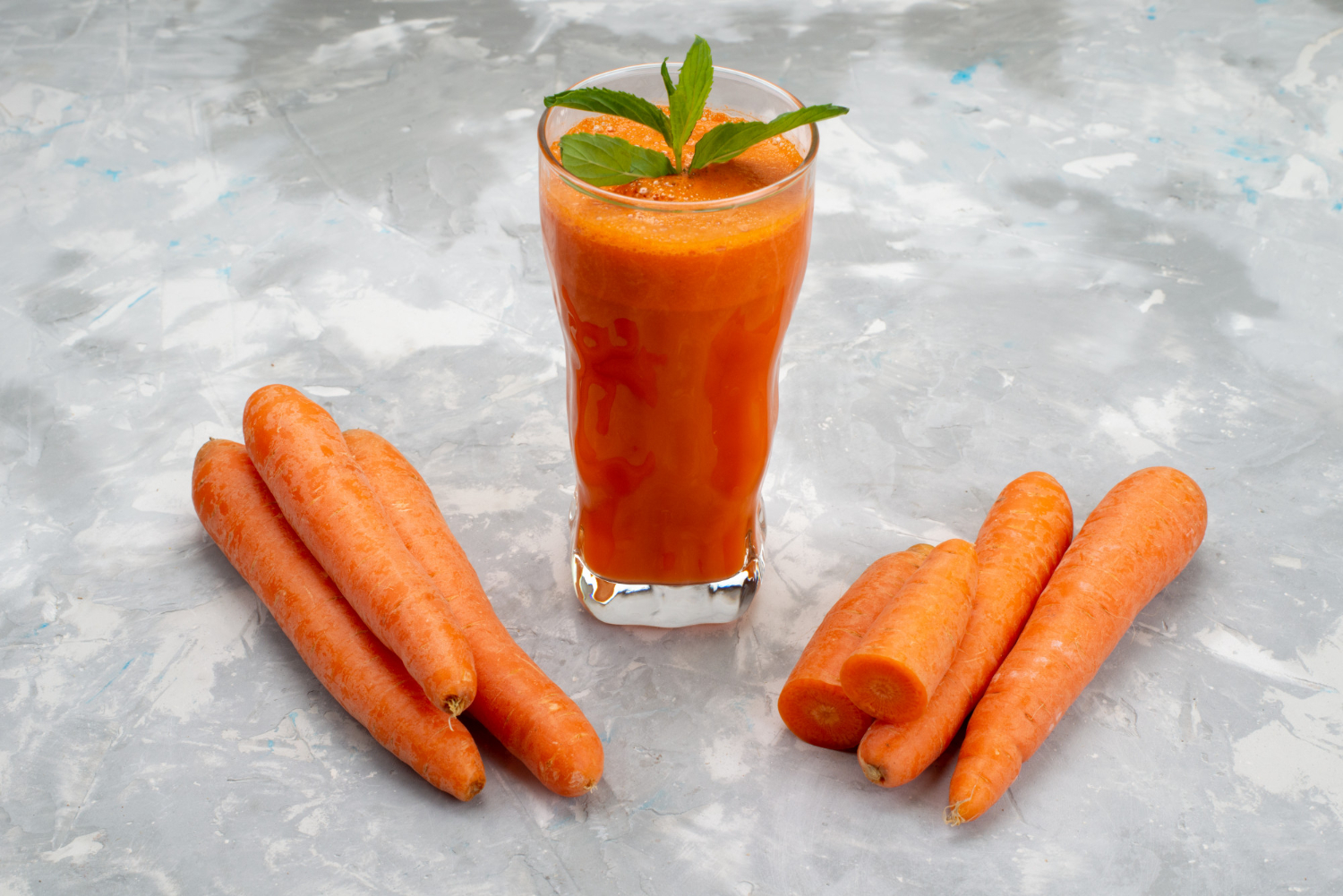 front view fresh carrot juice inside long glass with leaf along with fresh carrots vegetable health