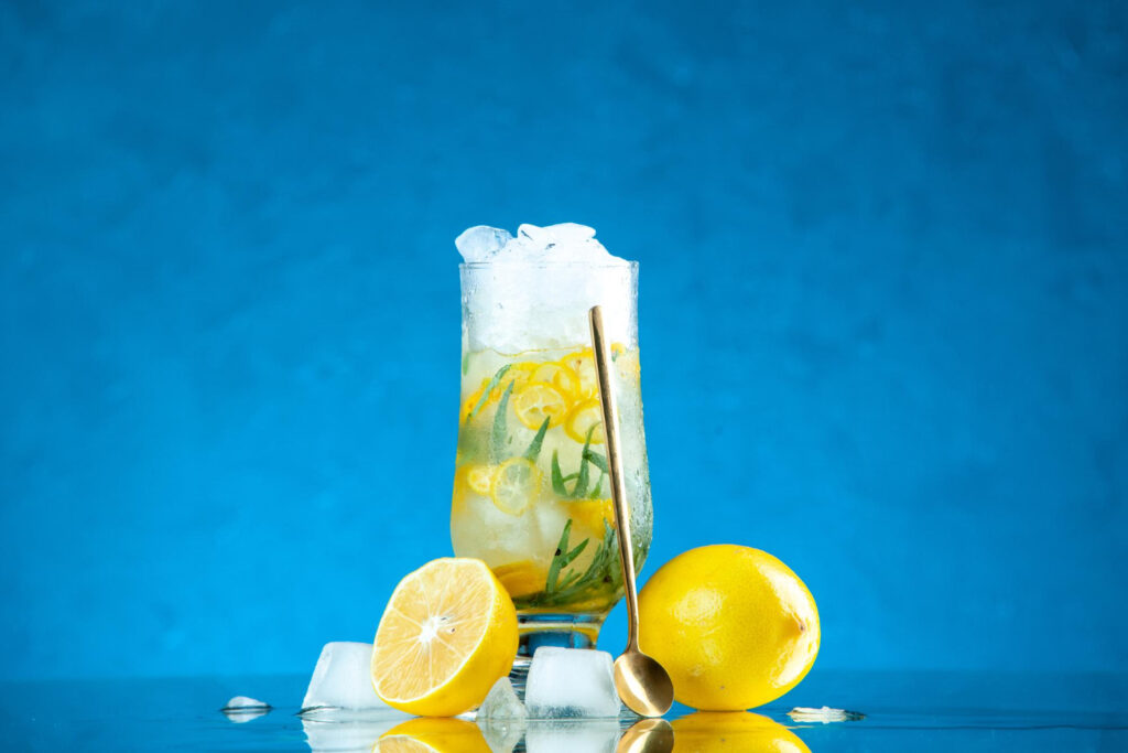 front view fresh cocktail with lemon ice blue background lemonade fruit bar club color juice drink
