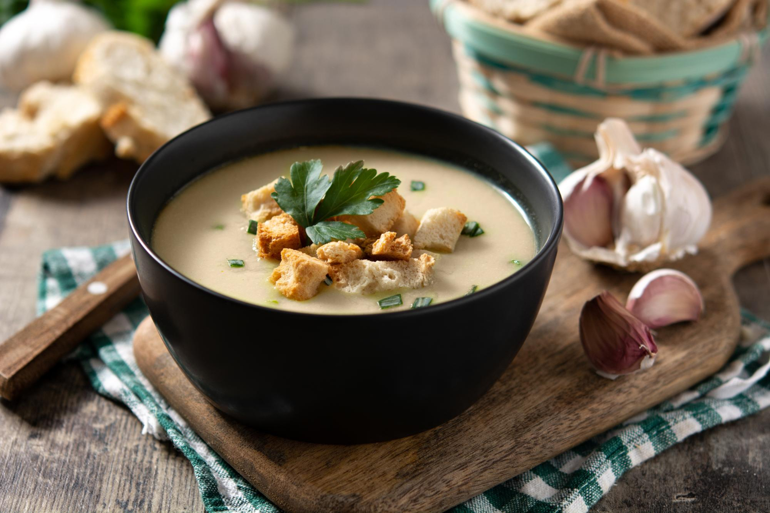 garlic soup topped with croutons bowl wooden table