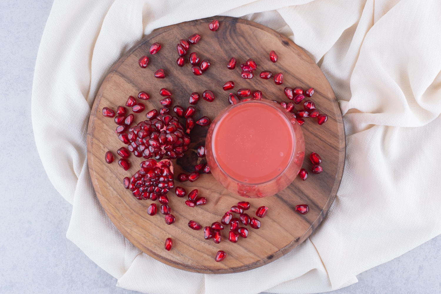 glass pomegranate juice wooden board with seeds high quality photo