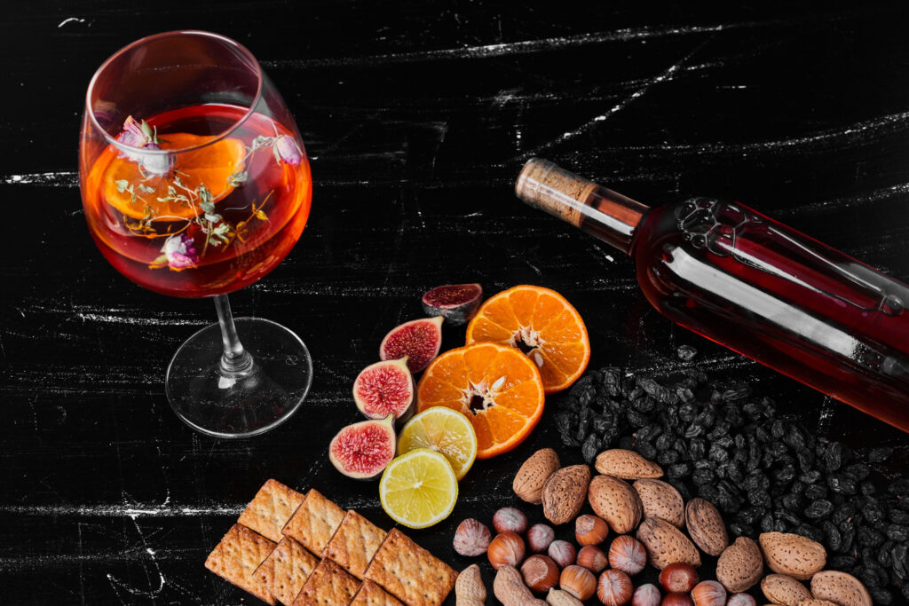 nuts fruits black background with wine