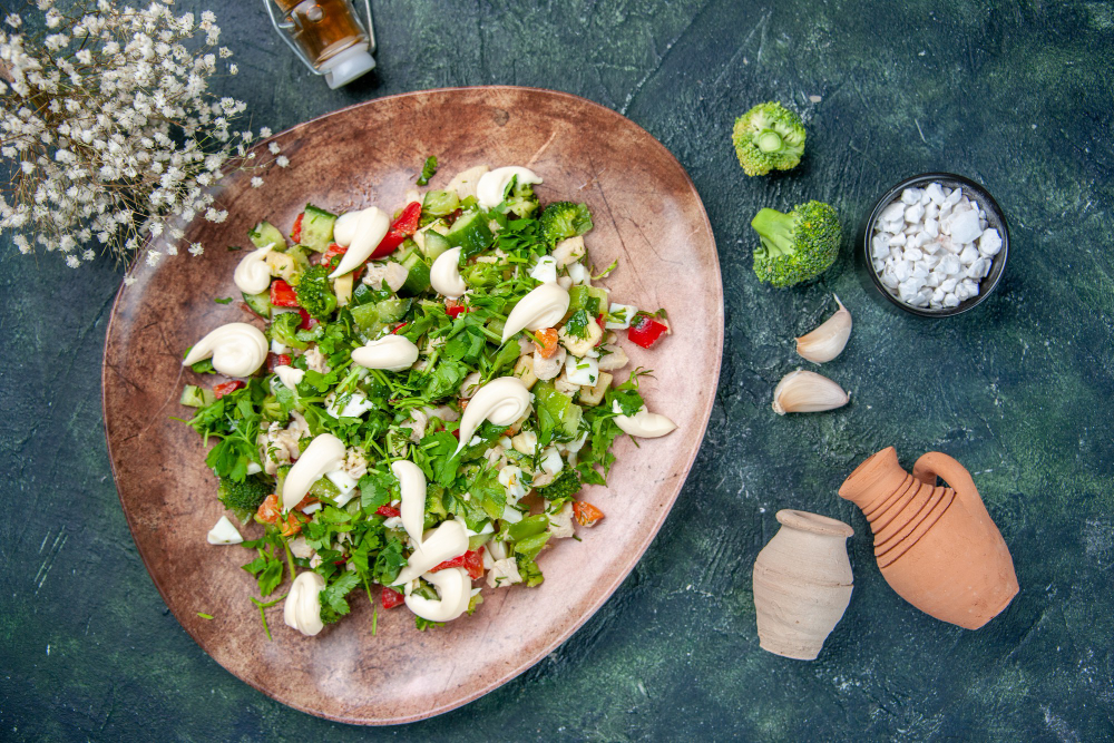 top view vegetable salad inside elegant plate with cutlery dark blue background color health lunch restaurant diet cuisine