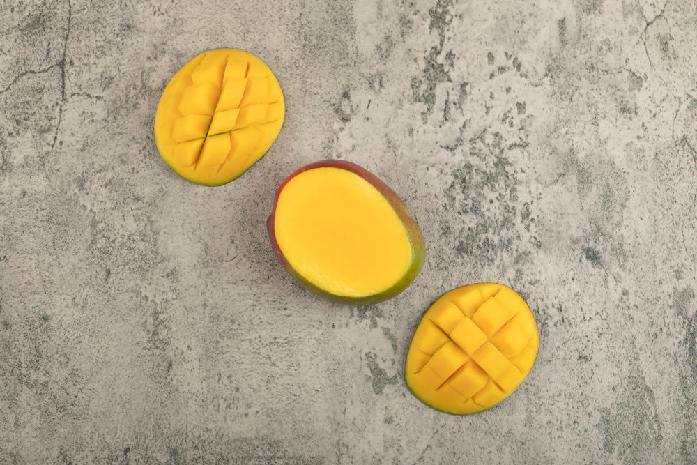 sliced tropical fruit mango with cubes marble surface